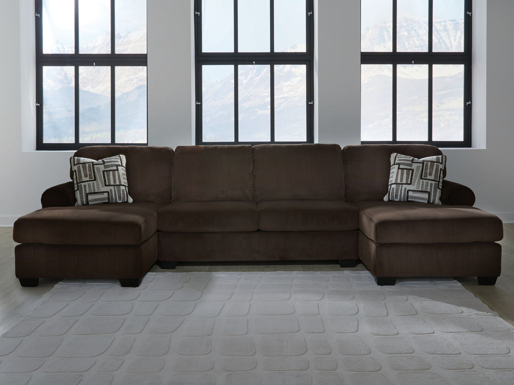 Chocolate sectional sofa with two chaise seats and patterned throw pillows