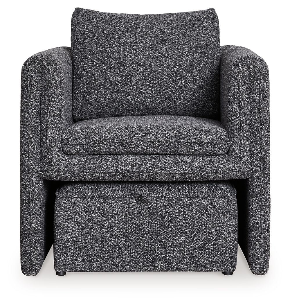 Charcoal accent chair with wide arms, textured upholstery, cushioned seat and backrest