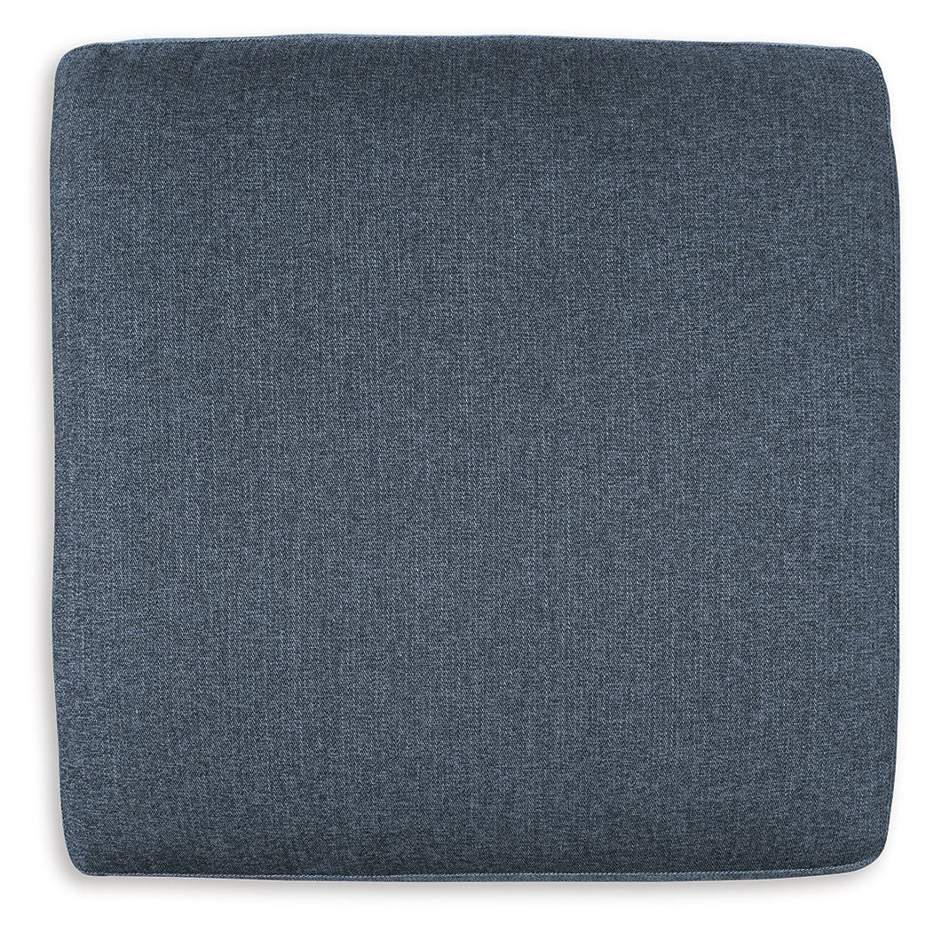 Ink blue fabric ottoman seat cushion with rounded corners, no legs visible