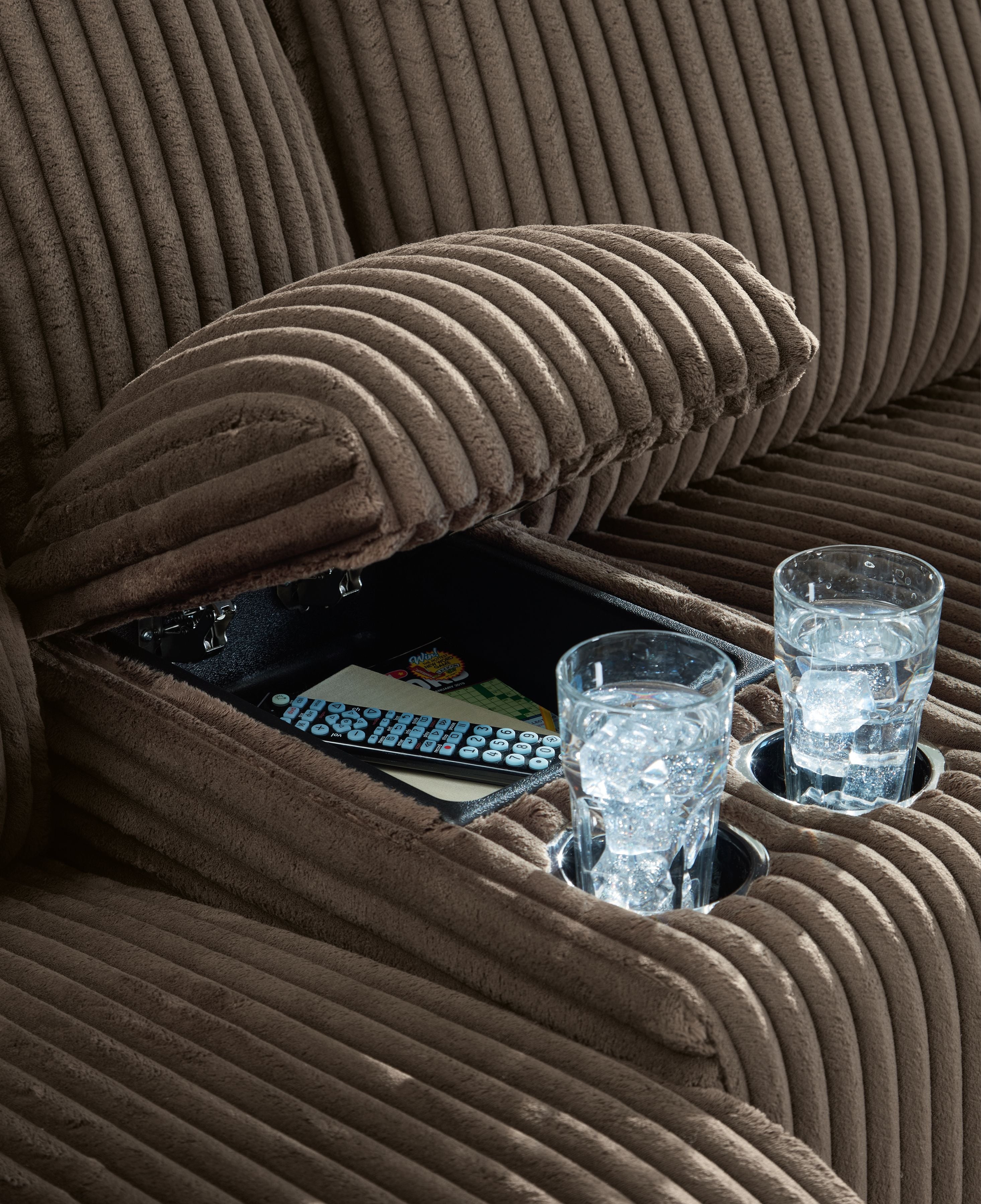 Dark brown corduroy-style upholstery with reclining mechanism and cup holders