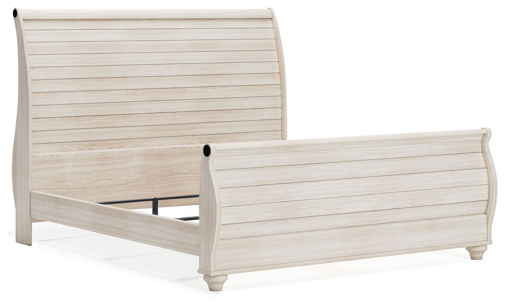 Beige sleigh bed frame with curved headboard and footboard, paneled slats