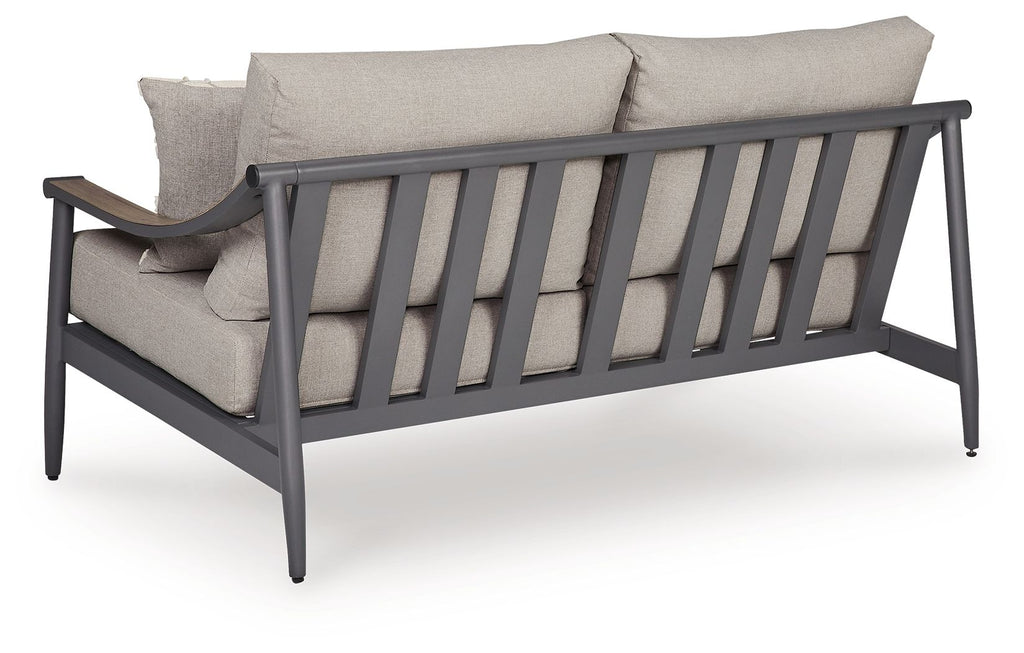 Gray outdoor loveseat with armrests and back slat panel, plus two throw pillows