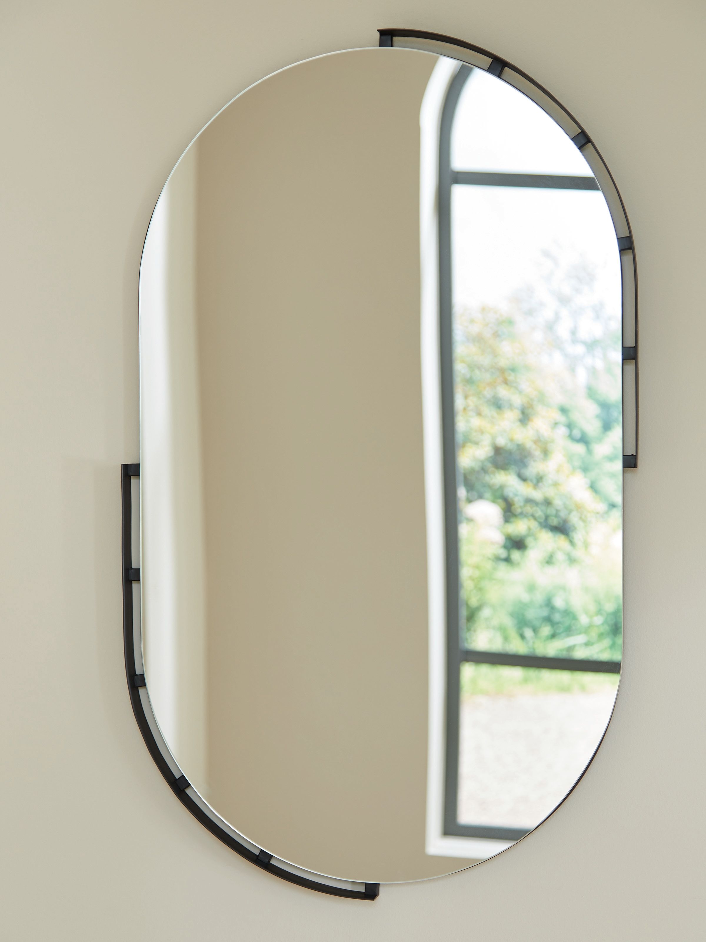 Wall-mounted arched oval mirror with black frame and reflective glass panel