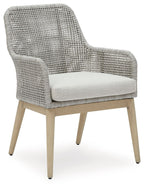 Gray woven armchair with white seat cushion and curved arms