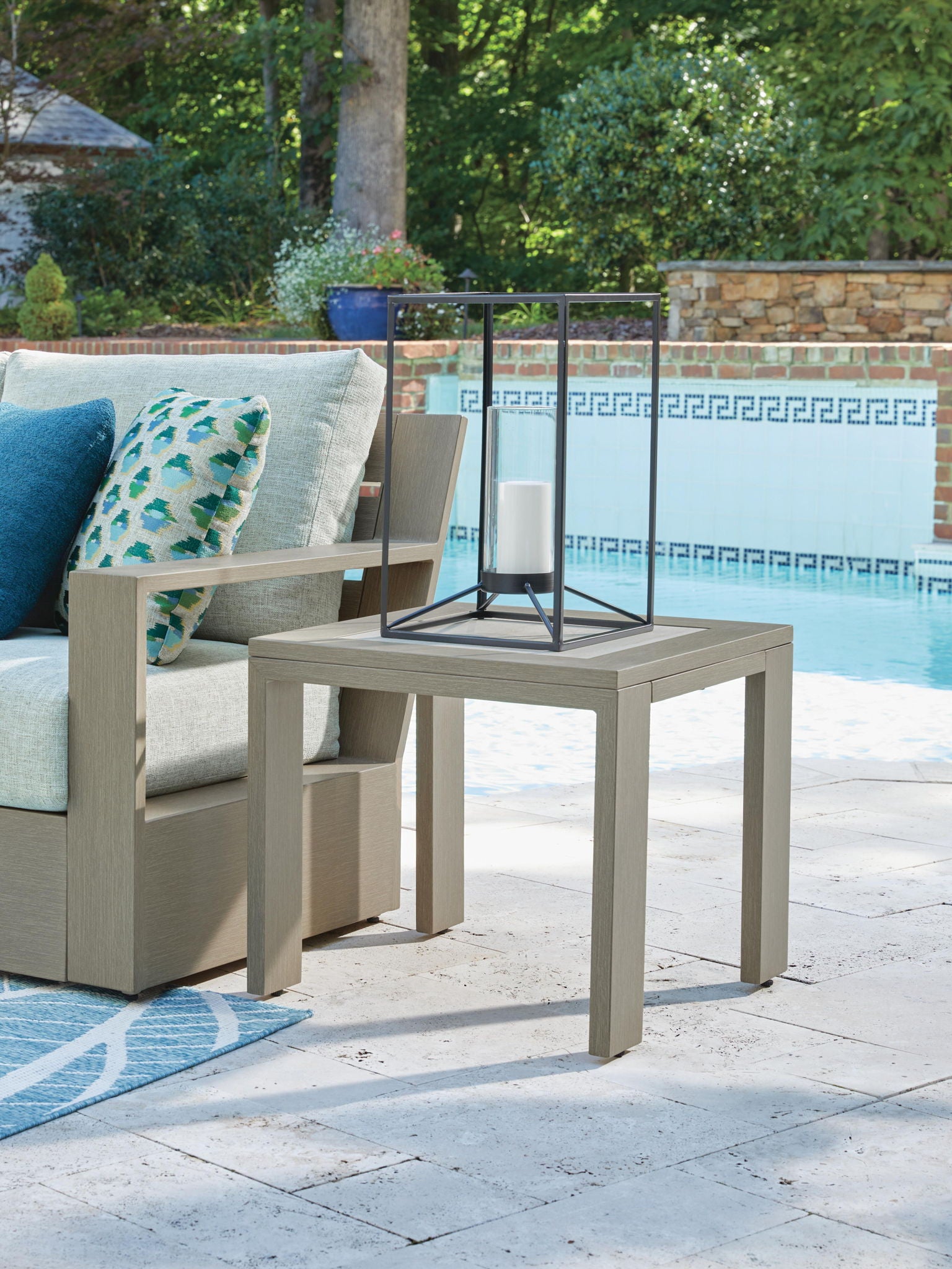 Beige square outdoor table with inset light top and four corner legs