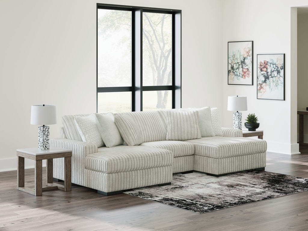 Off-white striped sectional sofa with chaise corner and decorative accent pillows.