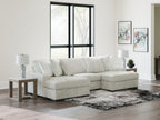 Off-white striped sectional sofa with chaise corner and decorative accent pillows.