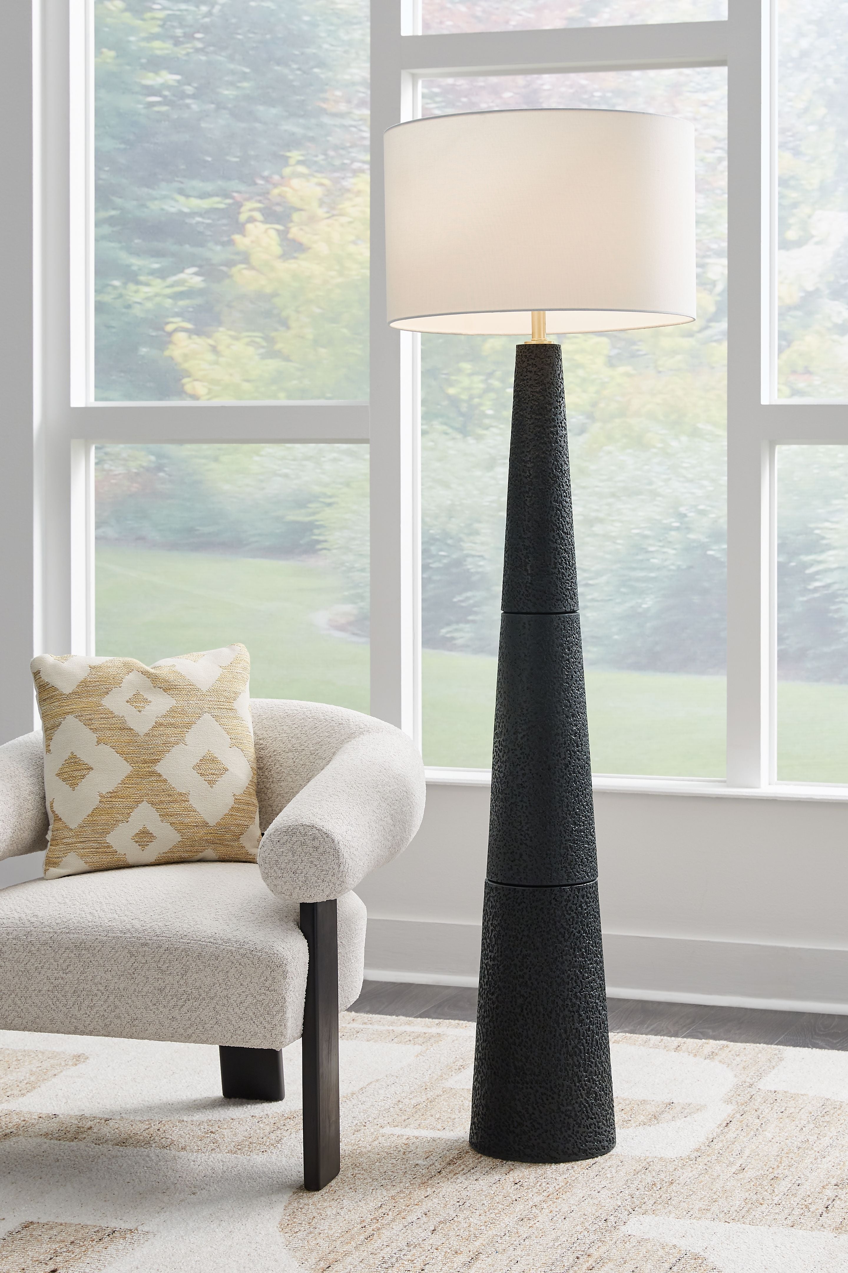 Black textured floor lamp with off-white fabric shade
