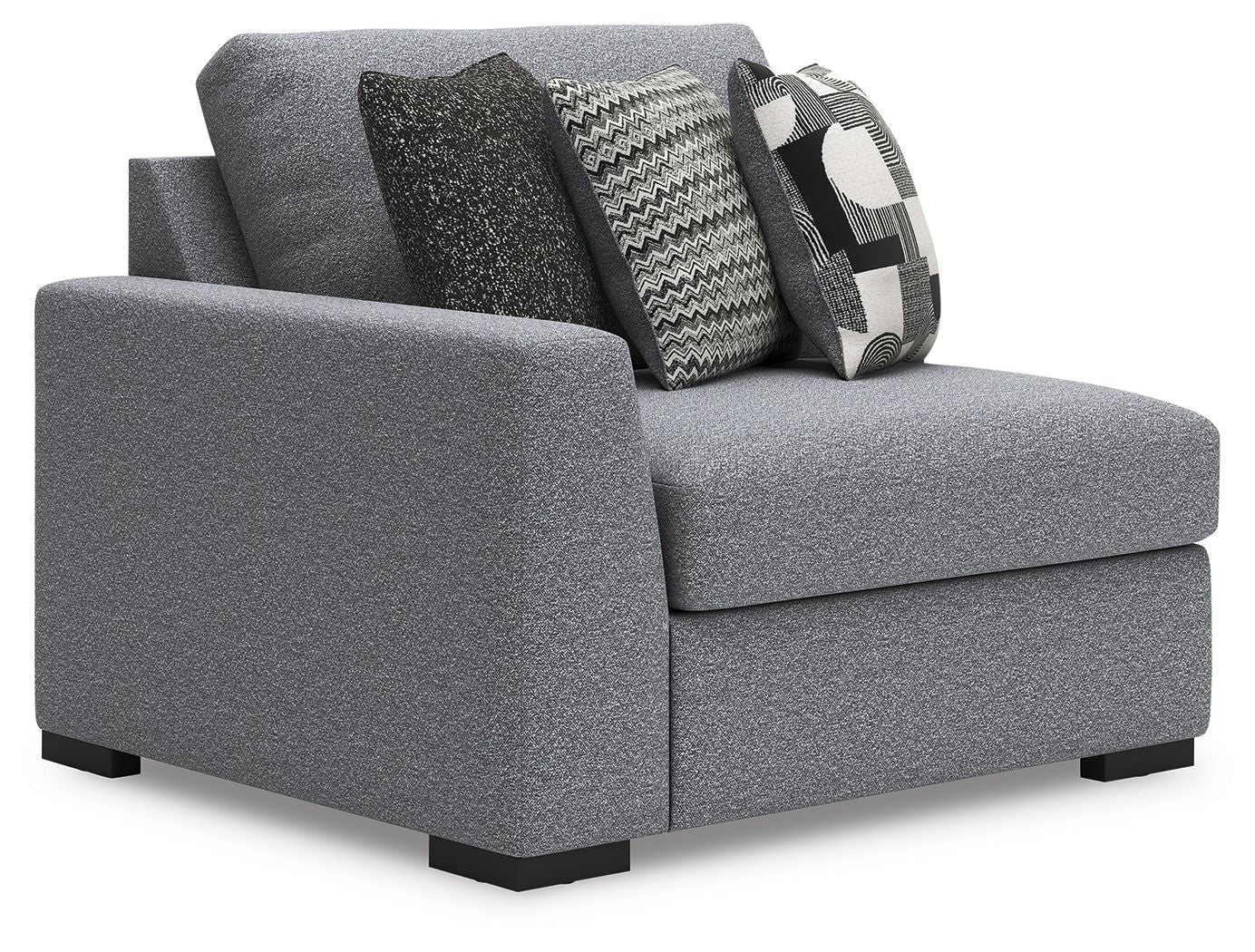 Gray corner chair with side profile, black legs, and zigzag and geometric throw pillows
