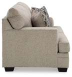 Light beige fabric loveseat with arm detail and two geometric patterned pillows