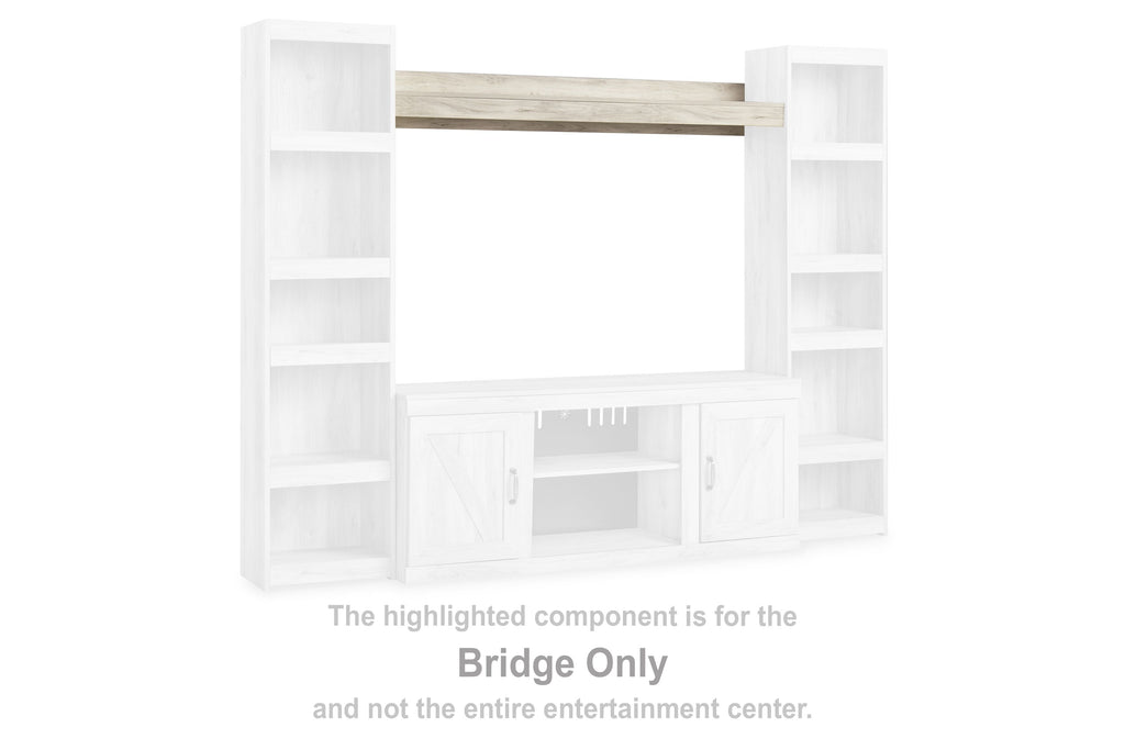Whitewash bridge entertainment center with open shelves and central cabinet opening