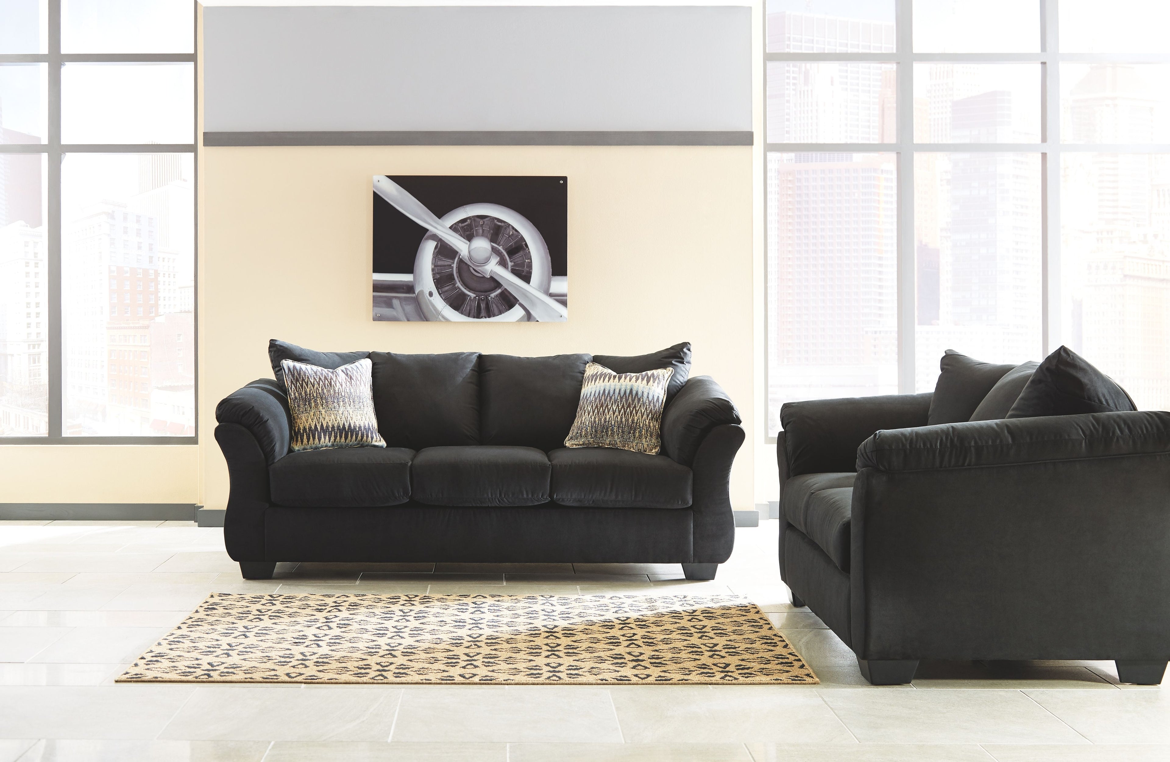 Living room set with dark sofa and loveseat, deep seating and tufted back pillows