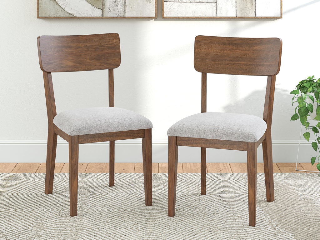 Set of 2 brown dining side chairs with rounded wood backs and light gray padded seats
