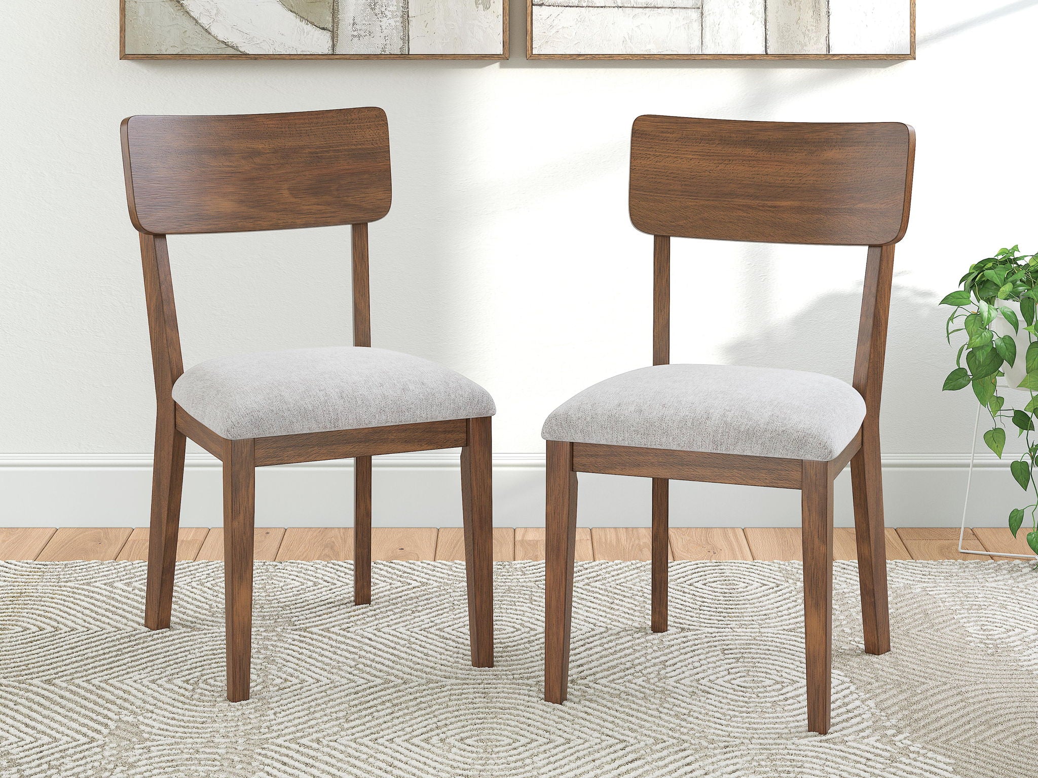 Set of 2 brown dining side chairs with rounded wood backs and light gray padded seats