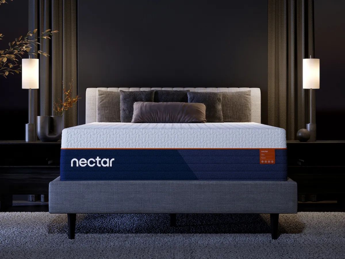 Blue Nectar hybrid mattress with white quilted top on a bed frame