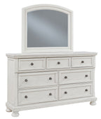 Antique white dresser with arched mirror, six drawers, metal knobs, turned feet.
