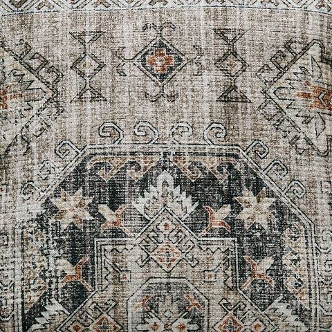 Close-up of decorative pillow fabric with dark gray geometric motif