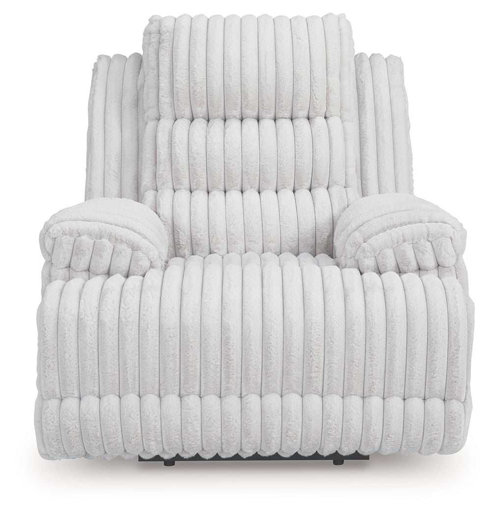 Light gray zero wall recliner with thick armrests, tufted backrest, and vertical channel quilting