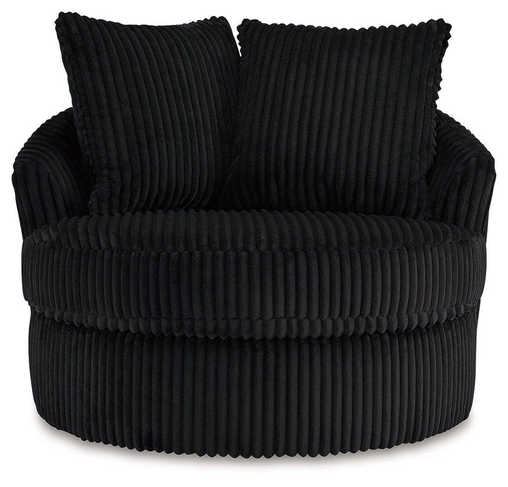 Swivel chair with ribbed black upholstery, two back pillows, and thick seat cushion