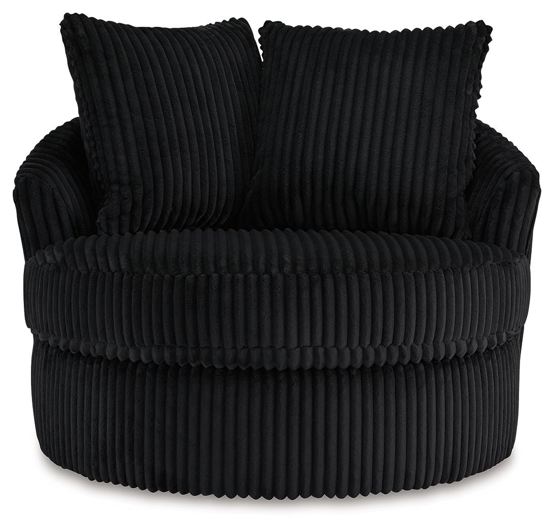 Swivel chair with ribbed black upholstery, two back pillows, and thick seat cushion