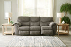 Taupe fabric sofa with cushioned back and three padded seat sections