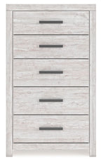 Whitewash five-drawer chest with dark bar handles and light wood-grain drawer fronts