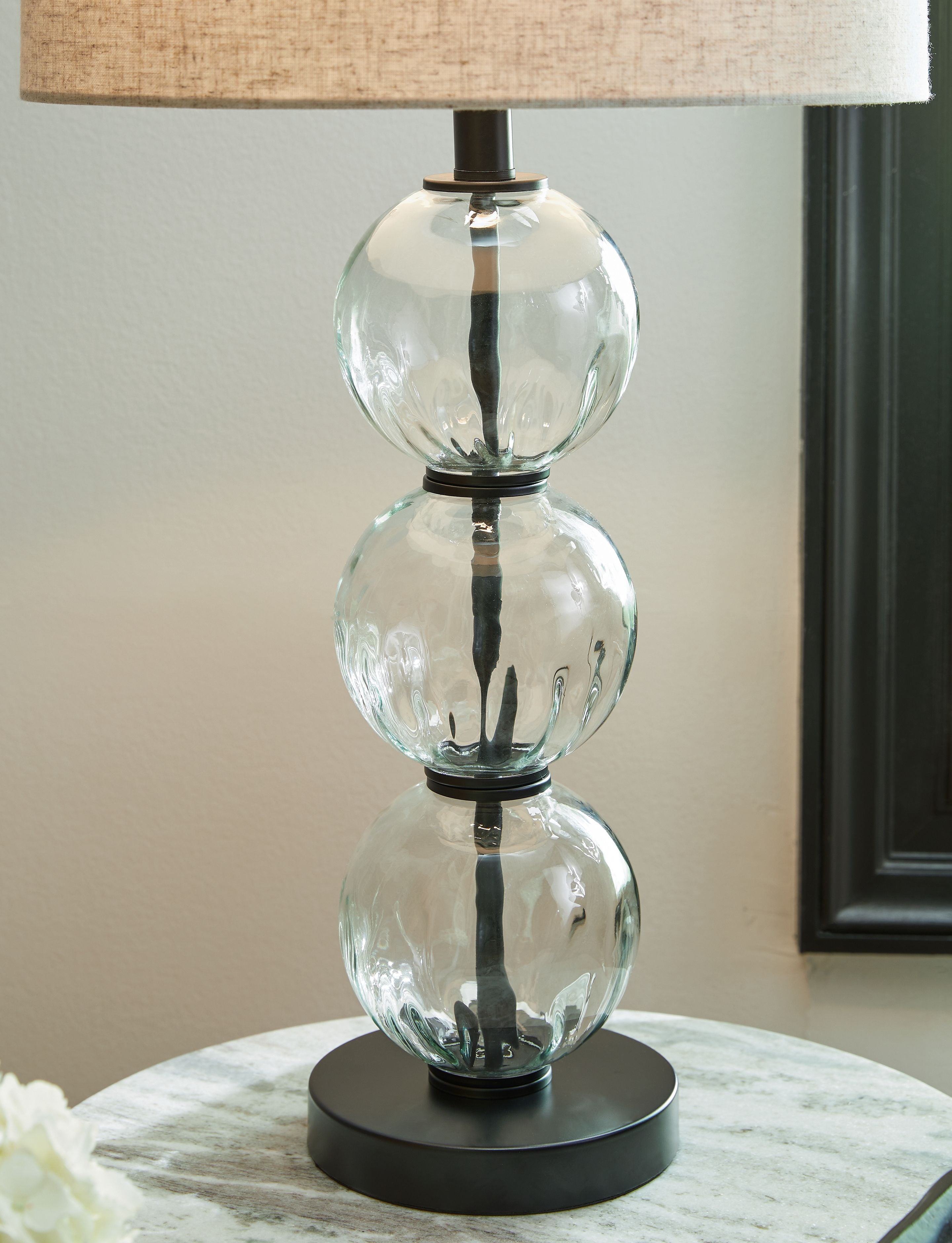 Glass table lamp base with clear stacked globe spheres and black platform