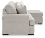 Gray upholstered armchair with rolled arms and decorative throw pillows