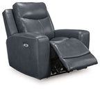Blue leather-look power recliner with tall adjustable headrest and wide padded arms