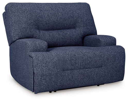 Wide seat power recliner in navy blue, tall backrest and padded arm cushions.