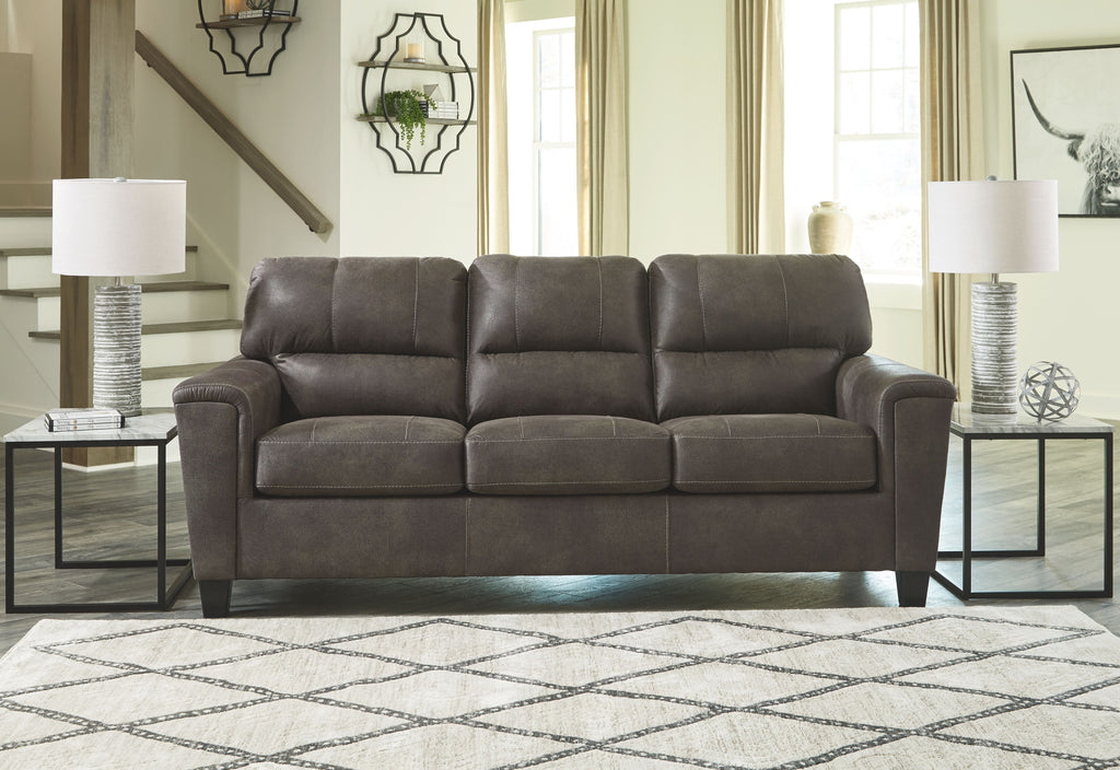 Dark gray sofa with square seat cushions and tufted back cushions