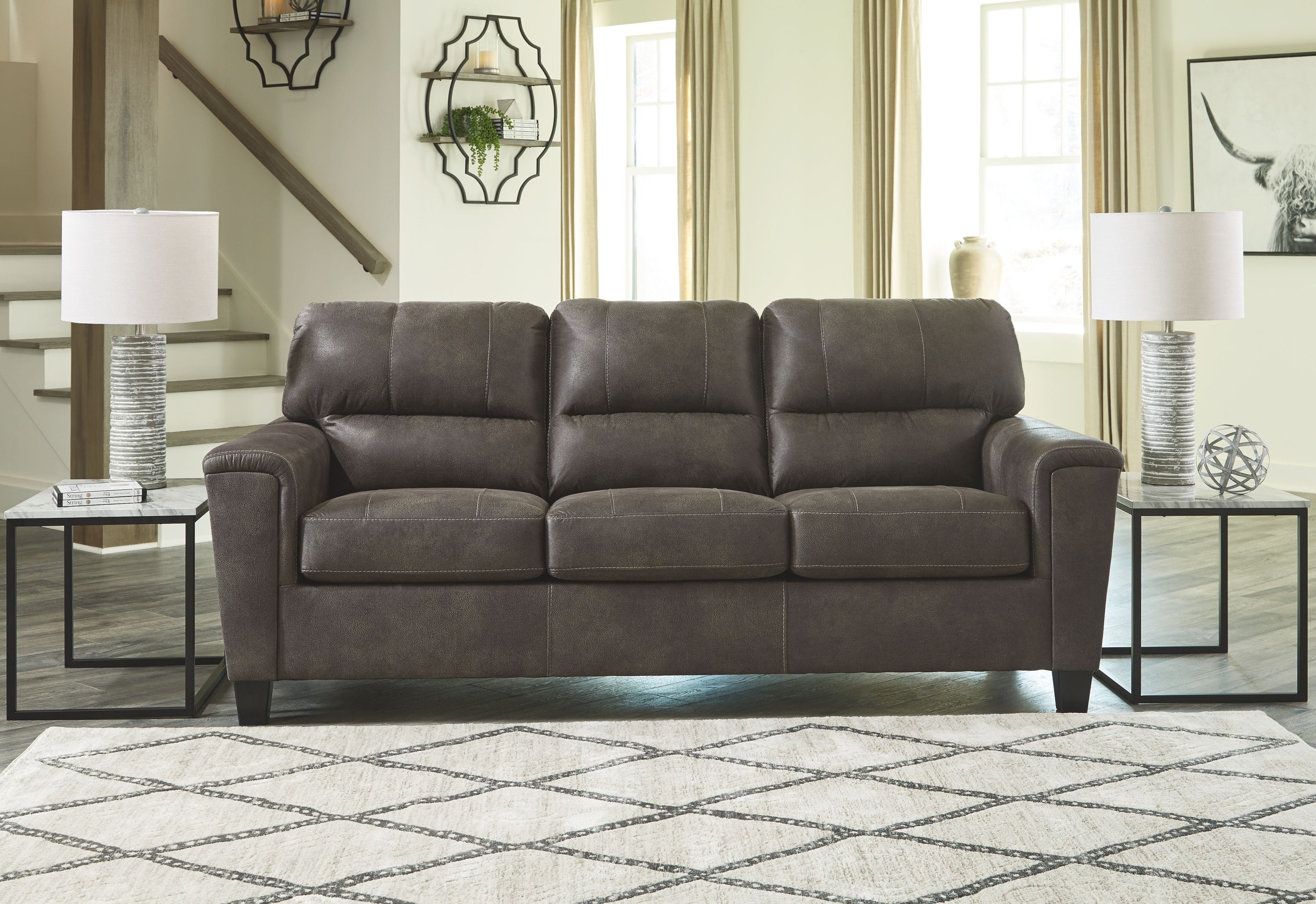 Dark gray sofa with square seat cushions and tufted back cushions