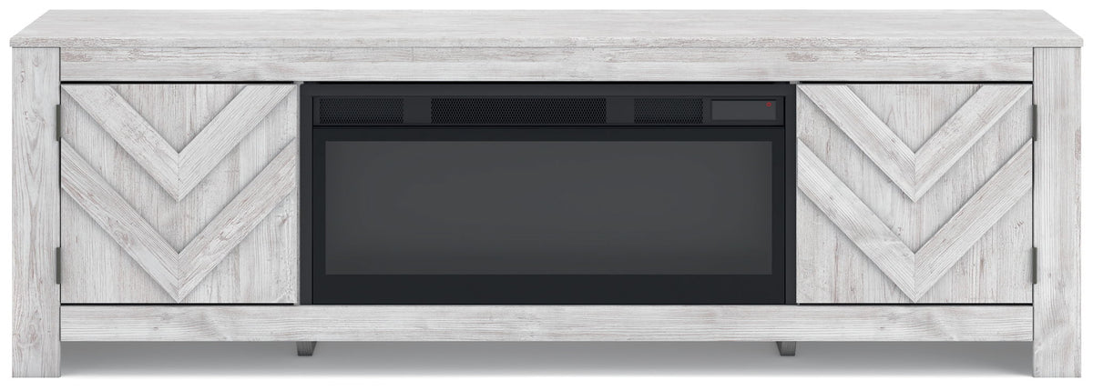 Light gray fireplace TV stand with chevron doors and dark fireplace opening