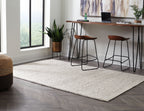 Beige Jossick woven rug with textured pattern, laid flat in living space