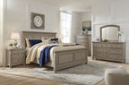 Lettner sleigh bed with drawers, gray frame and cream throw with blue blanket
