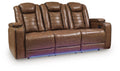 Brown leather power reclining sofa with adjustable headrests, padded arms and storage console