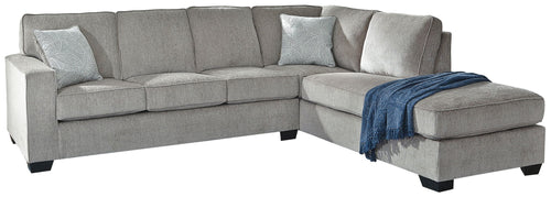 Light gray sectional sleeper sofa with right chaise, tufted cushions, and armrest pillows