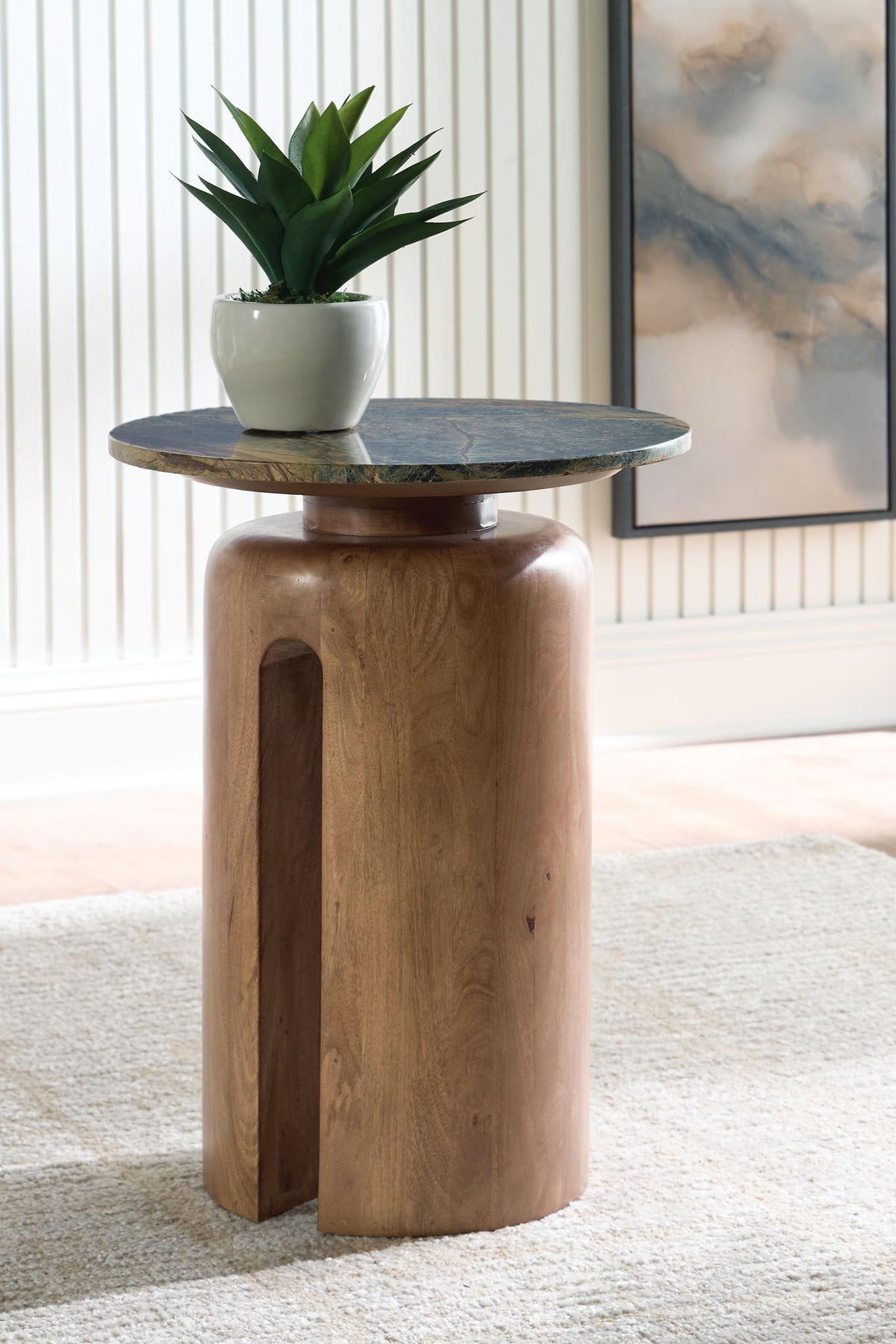 Wood accent table with circular green top, pedestal base, and cutout window