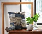 Patchwork throw pillow in dark blue and tan with gray tufted fringe accents