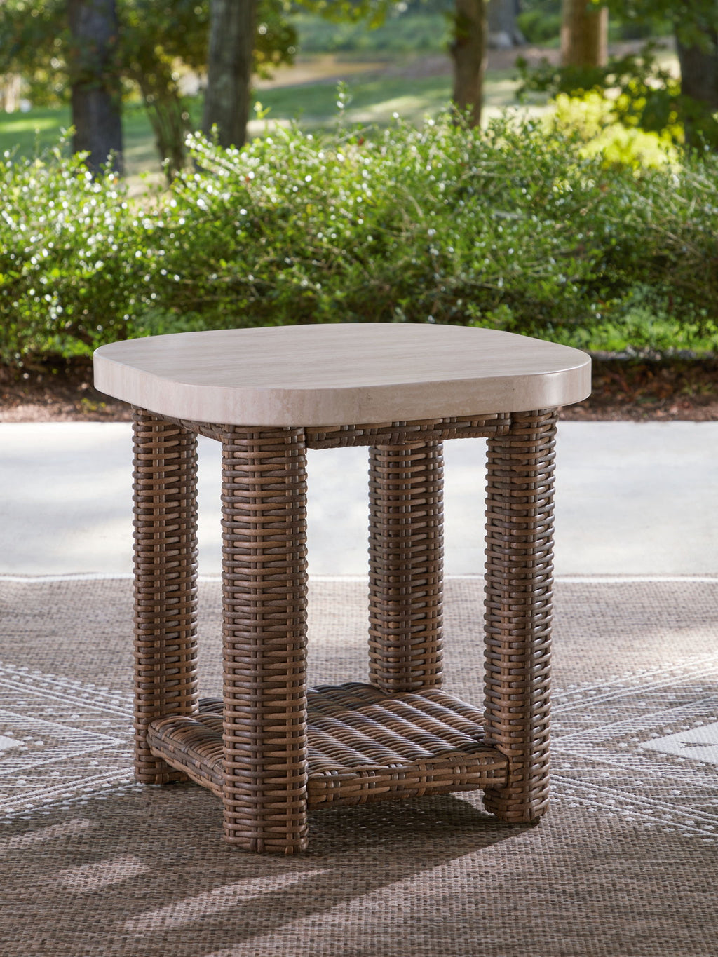 Beige woven end table with round top and lower storage shelf