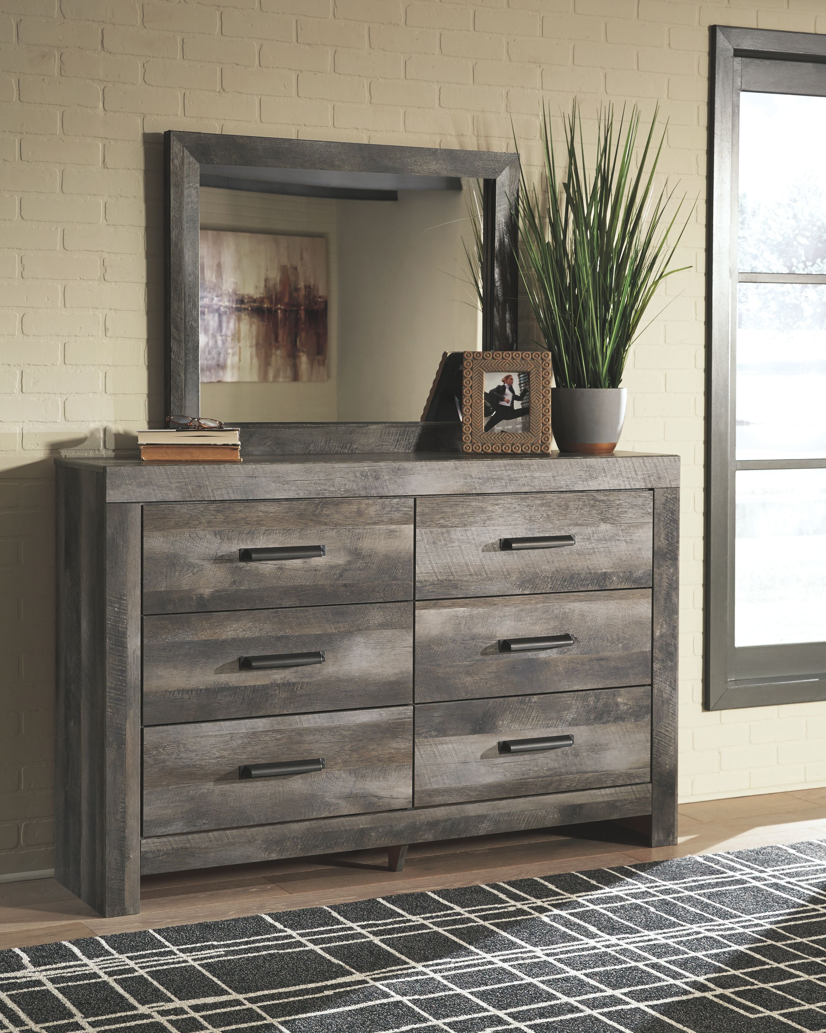 Gray dresser with framed mirror and six drawers with bar handles