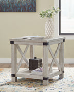 Whitewashed rectangular end table with X-frame sides, dark brackets, top surface with decor