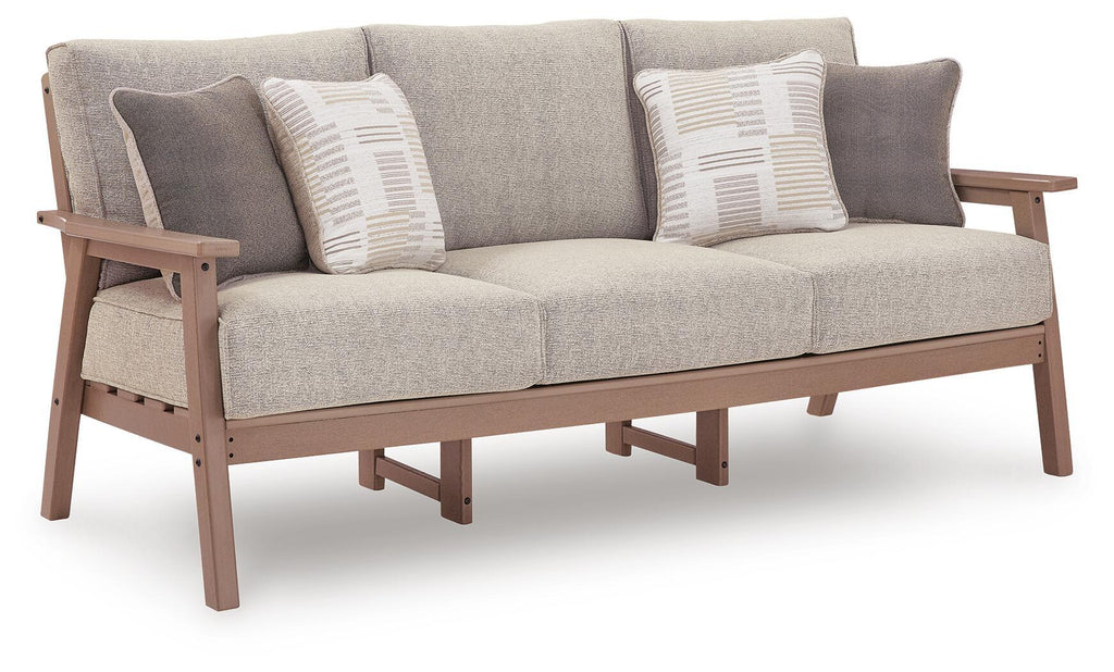 Light gray sofa with two striped throw cushions and dark wood arms and legs
