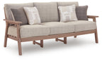 Light gray sofa with two striped throw cushions and dark wood arms and legs