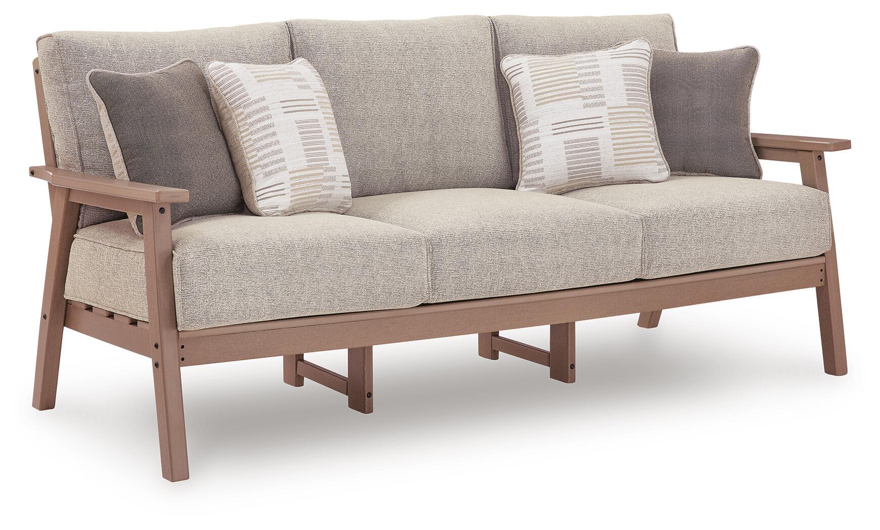 Light gray sofa with two striped throw cushions and dark wood arms and legs