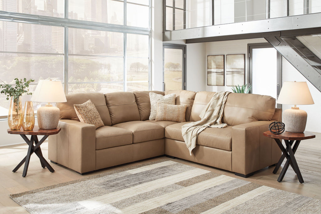 Light brown fabric sectional sofa with chaise and matching ottoman, decorative pillows