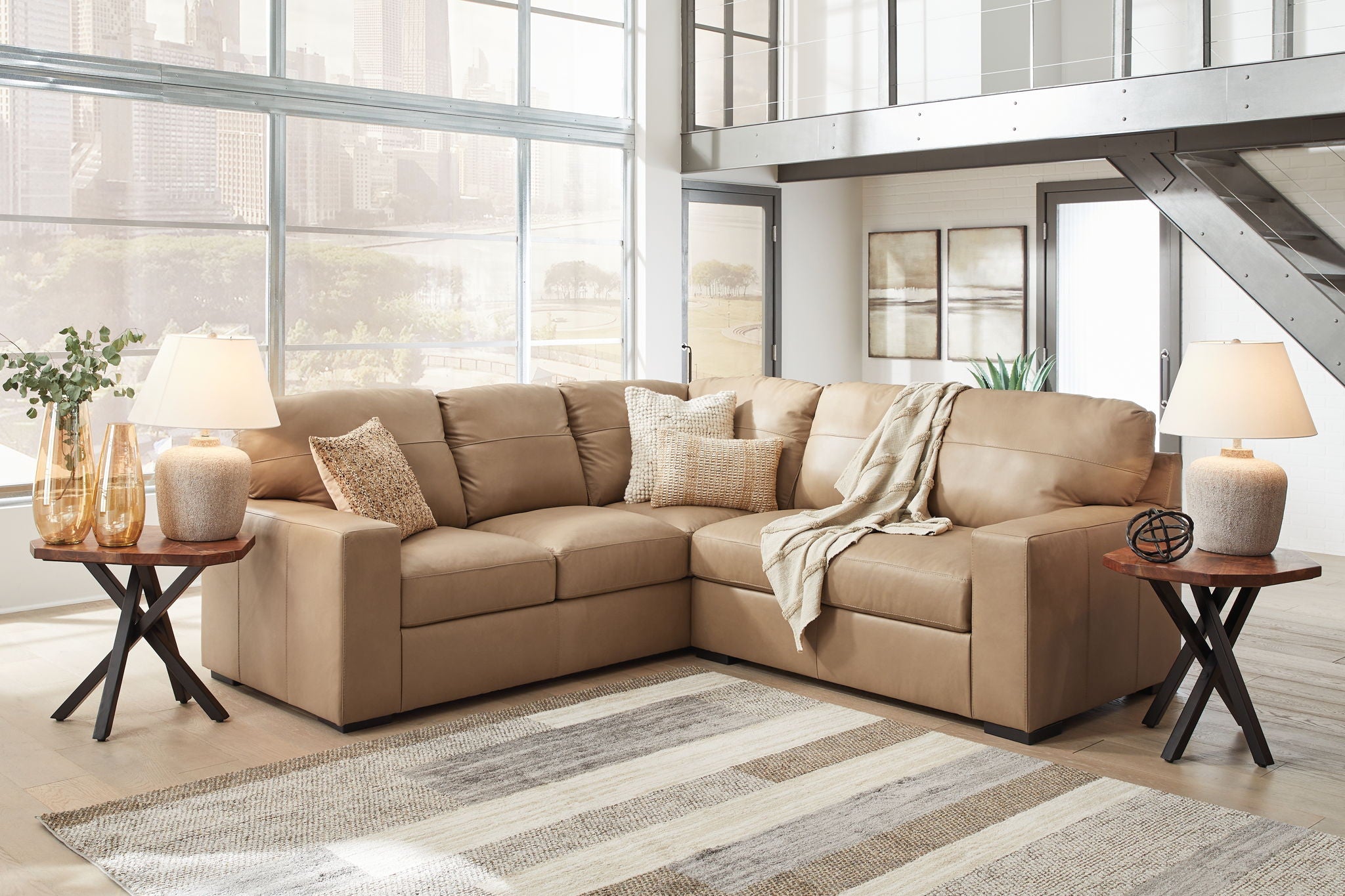 Light brown fabric sectional sofa with chaise and matching ottoman, decorative pillows