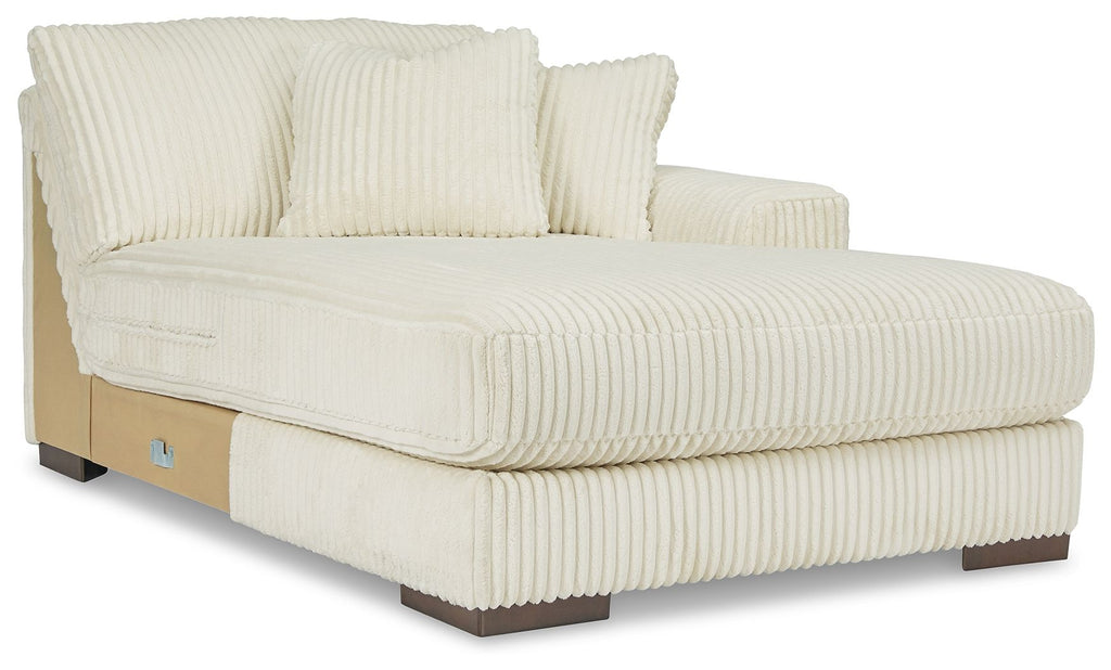 Ivory right-arm chaise with tufted seat, armrest cushion, and two back pillows