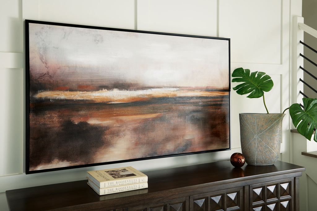 Abstract wall art print in brown, black, and orange hues hanging on wall, black frame