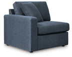 Dark blue upholstered corner chair with track arms and removable back cushions